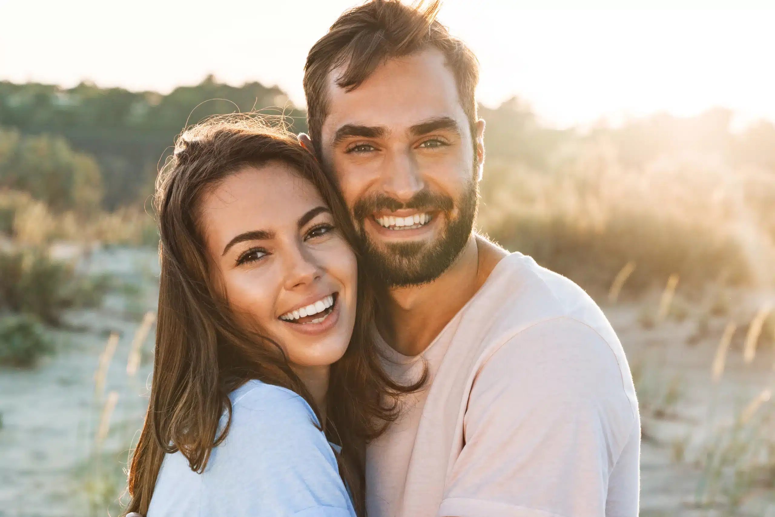 AdobeStock_277685185 (9)-converted-from-jpeg Smiling couple outdoors at sunset showing bright, healthy teeth after visiting Gridley Dental